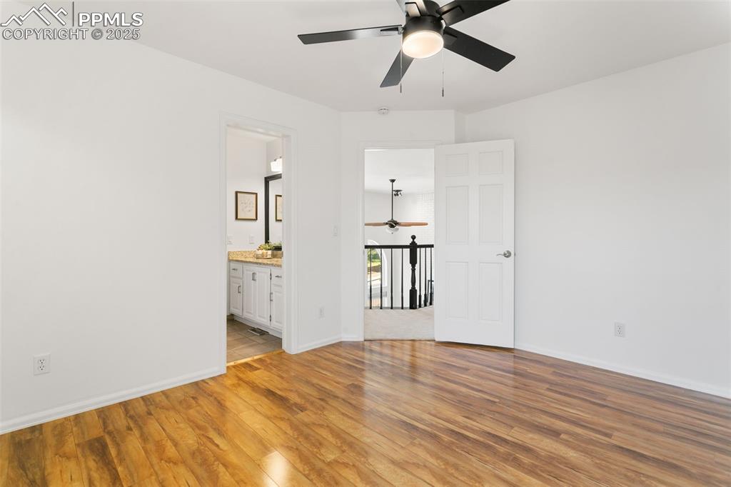 Spare room with a ceiling fan and light wood-style flooring