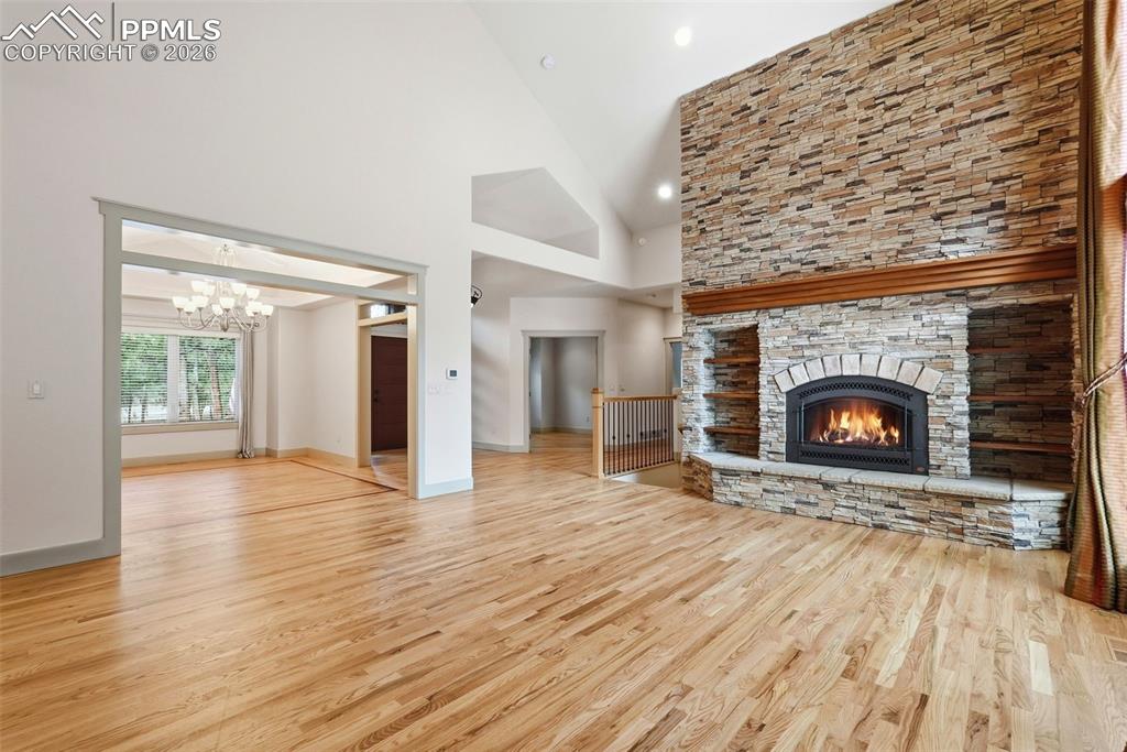 Main level Family Room or Den with a stone fireplace, oak floors and wetbar