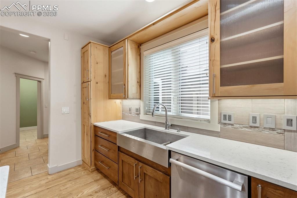 Kitchen featuring glass insert cabinets, stainless steel apron sink , dishwasher, second chef prep sink.