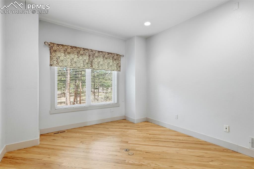 Office room featuring wood floors, valance, recessed lighting