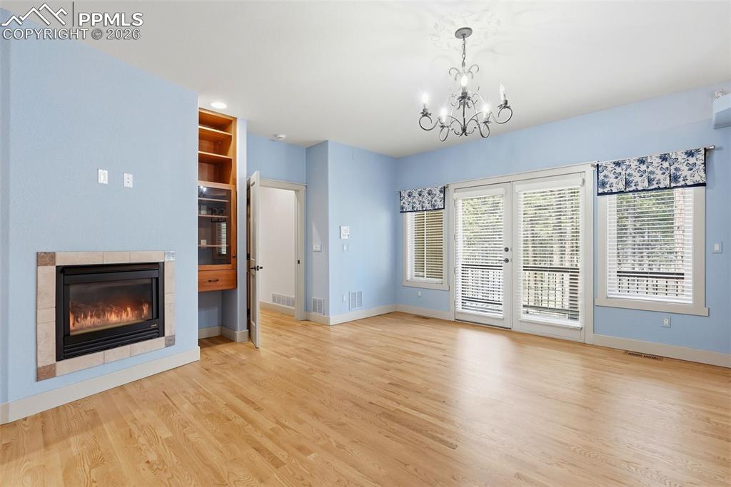 Master Bedroom with chandelier oak floors and private balcony