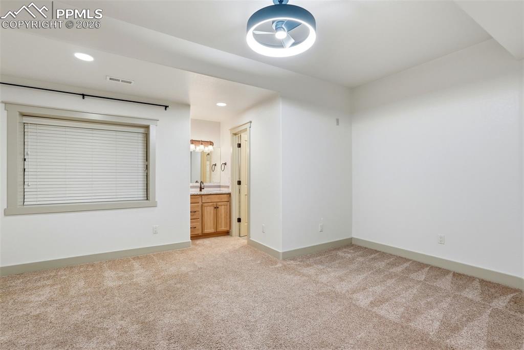 4th bedroom featuring light colored carpet, recessed lighting, and ensuite bathroom