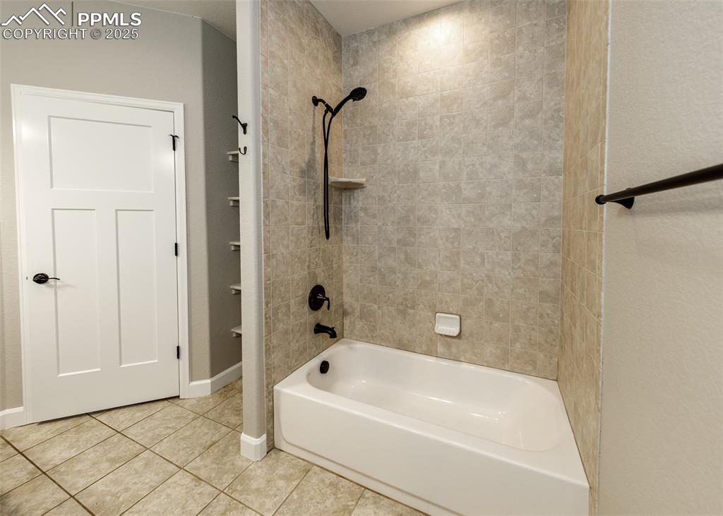 Pretty custom tile in the primary bath tub/shower.