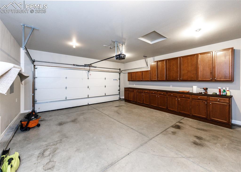 Cabinets galore in the attached garage. Uppers and lowers and countertops.