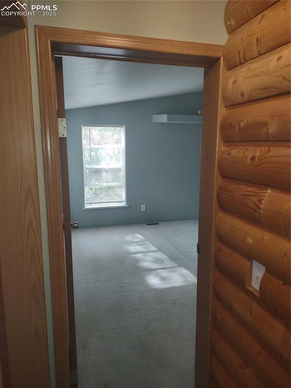 Hallway connecting three bedrooms and full bath.