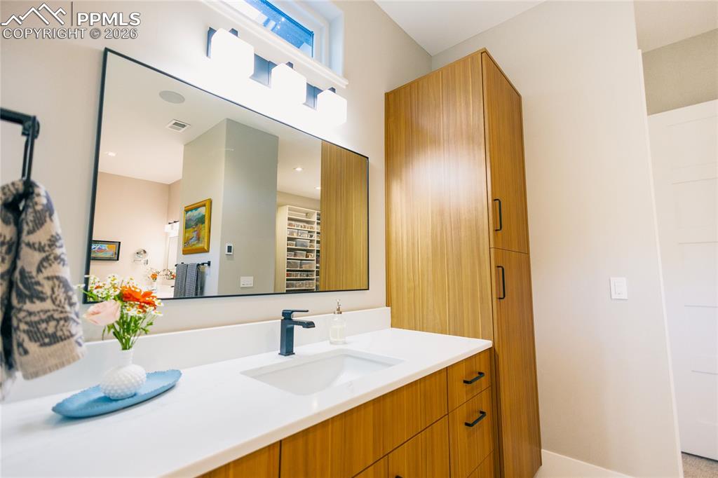 Full bath with vanity and baseboards