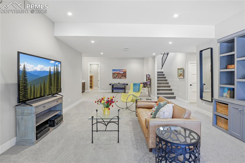 Living area featuring recessed lighting and light carpet