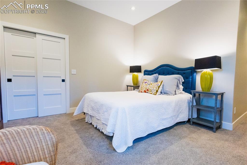 Carpeted bedroom featuring baseboards