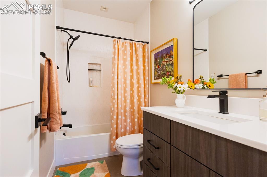 Bathroom with vanity and shower / bath combo with shower curtain