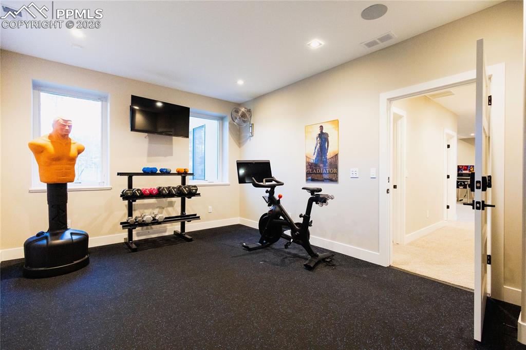 Workout room featuring baseboards and recessed lighting