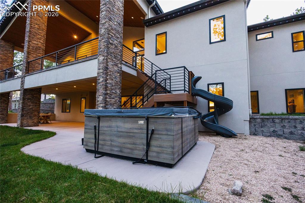 Back of property featuring stucco siding, a patio area, and a balcony