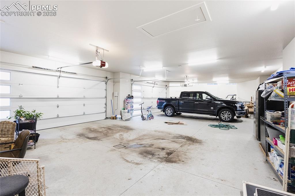 Garage featuring a garage door opener