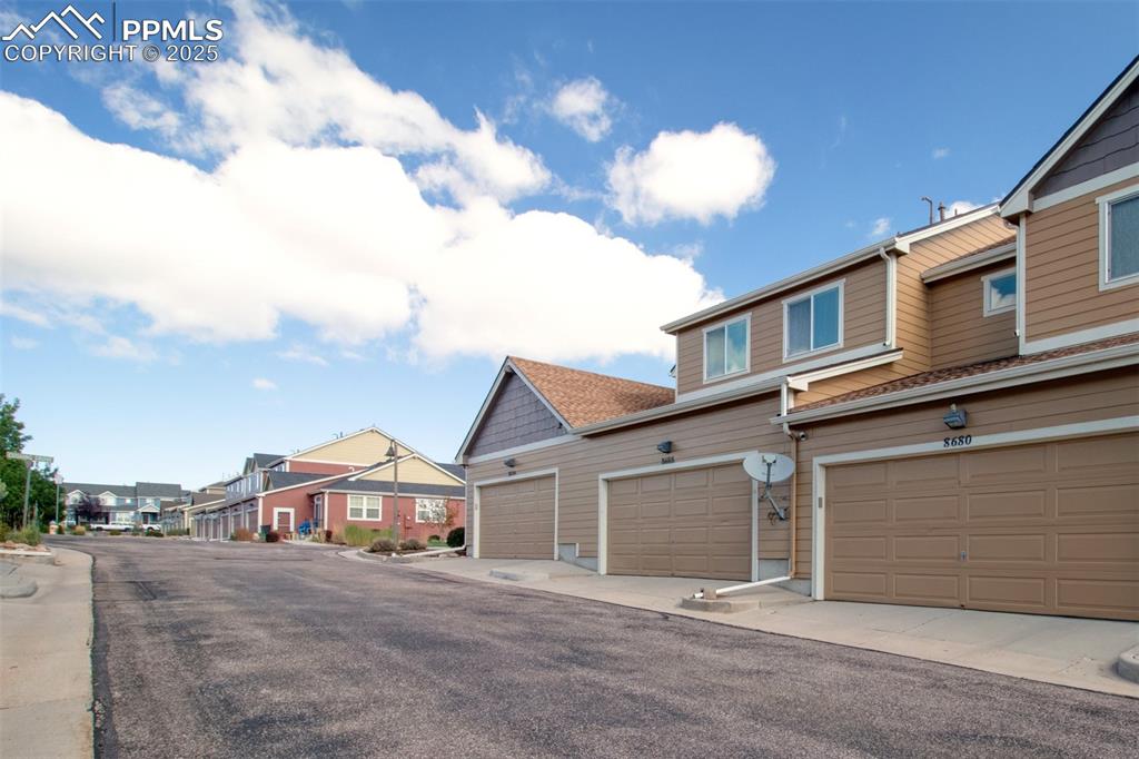 View of asphalt road featuring a residential view