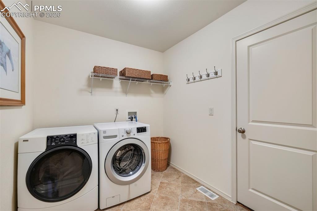 main level laundry room with spacious coat closet