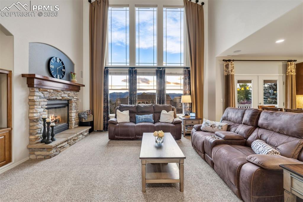 A gas burning fireplace, wood mantle and raised hearth 