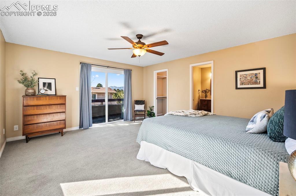 Primary suite offering a calm, restorative atmosphere
and the Private balcony with tranquil views of Pikes Peak + Woodmoor Lake