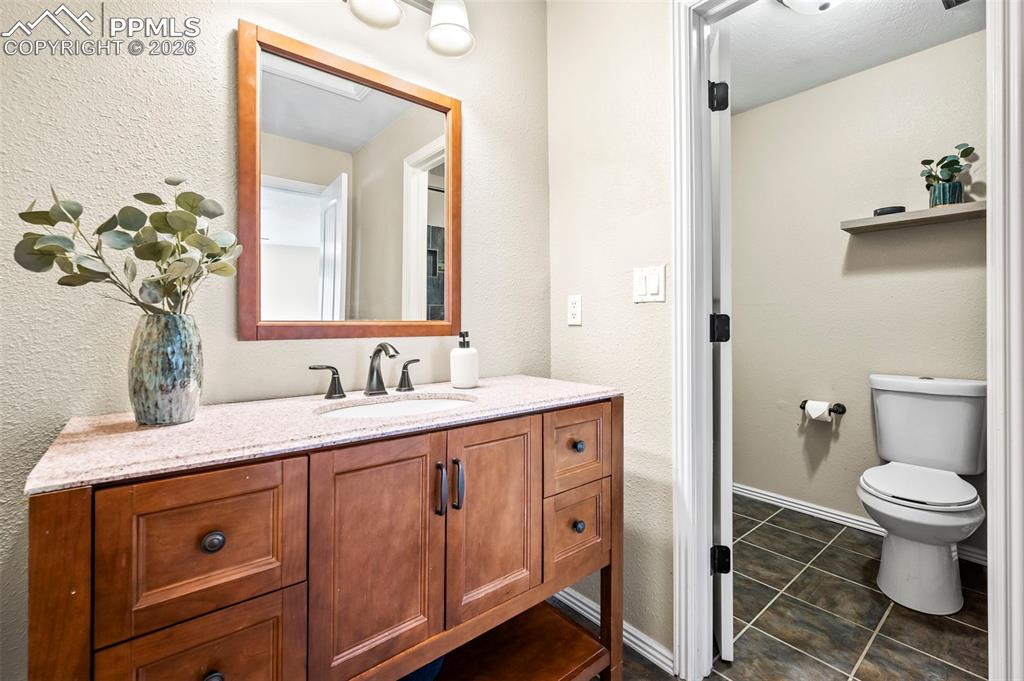 Private Primary Ensuite with updated vanity w/granite countertop, tile floors and tub/shower