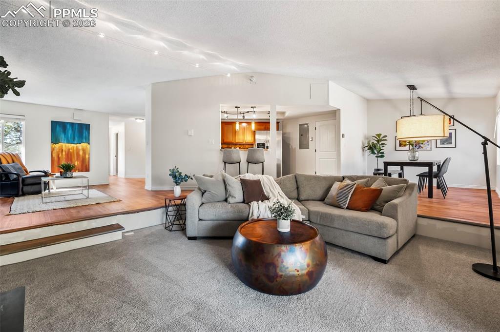 Sunken living room anchored by a wood-burning fireplace, creating a warm focal point.  