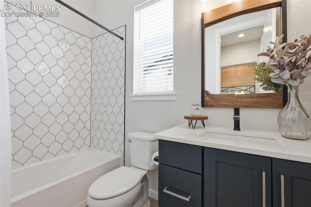 Full bathroom with upgraded tile and quartz countertops