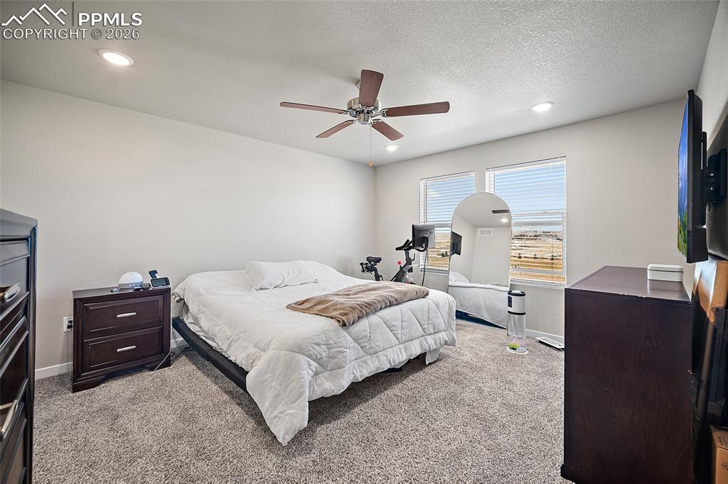 Primary Bedroom with a ceiling fan