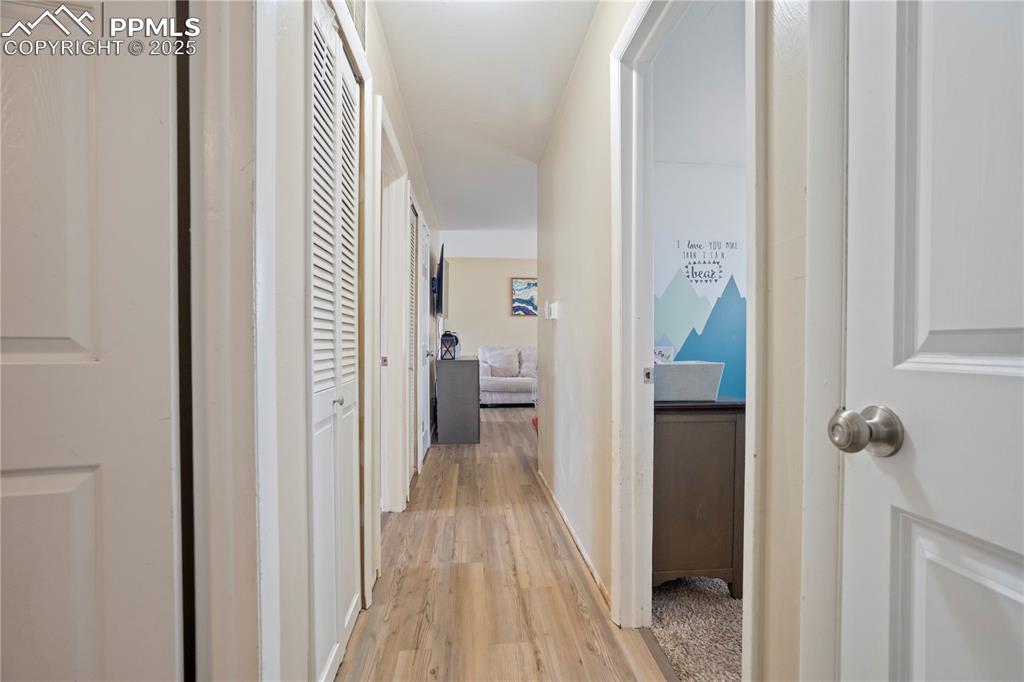 Corridor with light wood finished floors