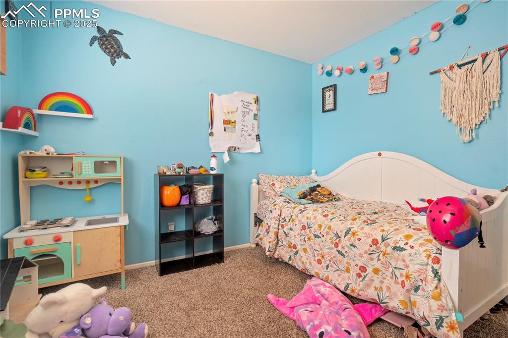 Carpeted bedroom with baseboards