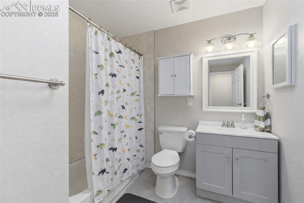Full bath with vanity and shower / tub combo with curtain