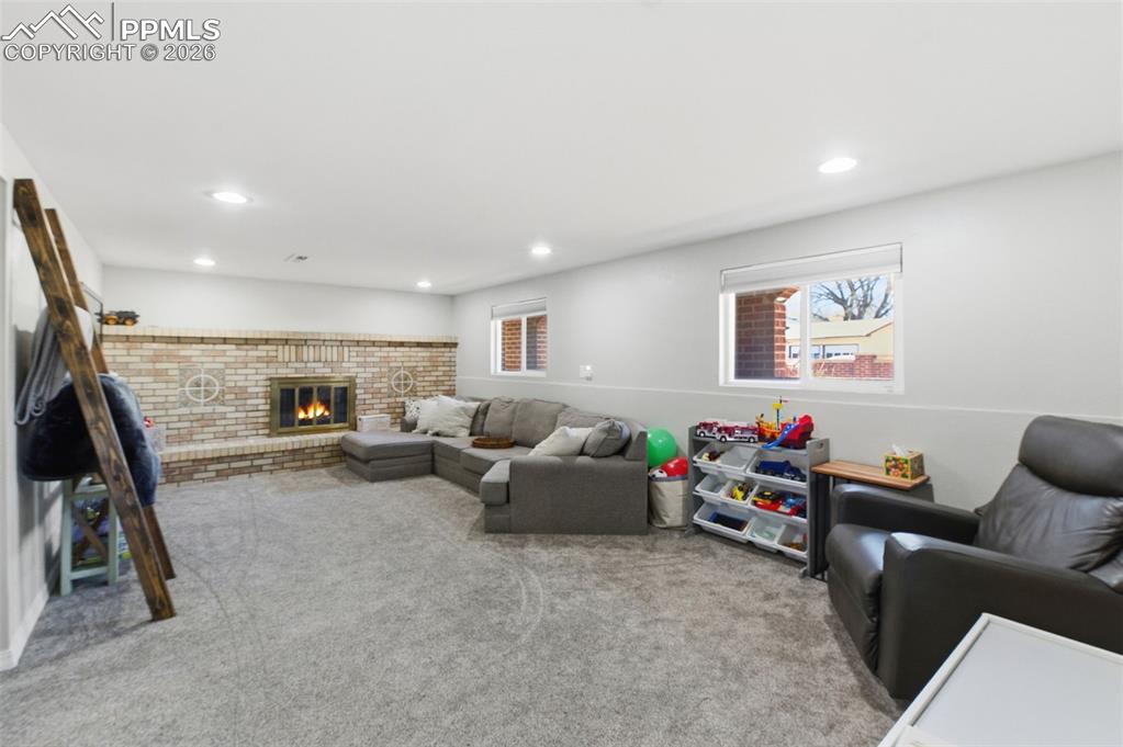 Lower Level Family Room with a wood burning fireplace.