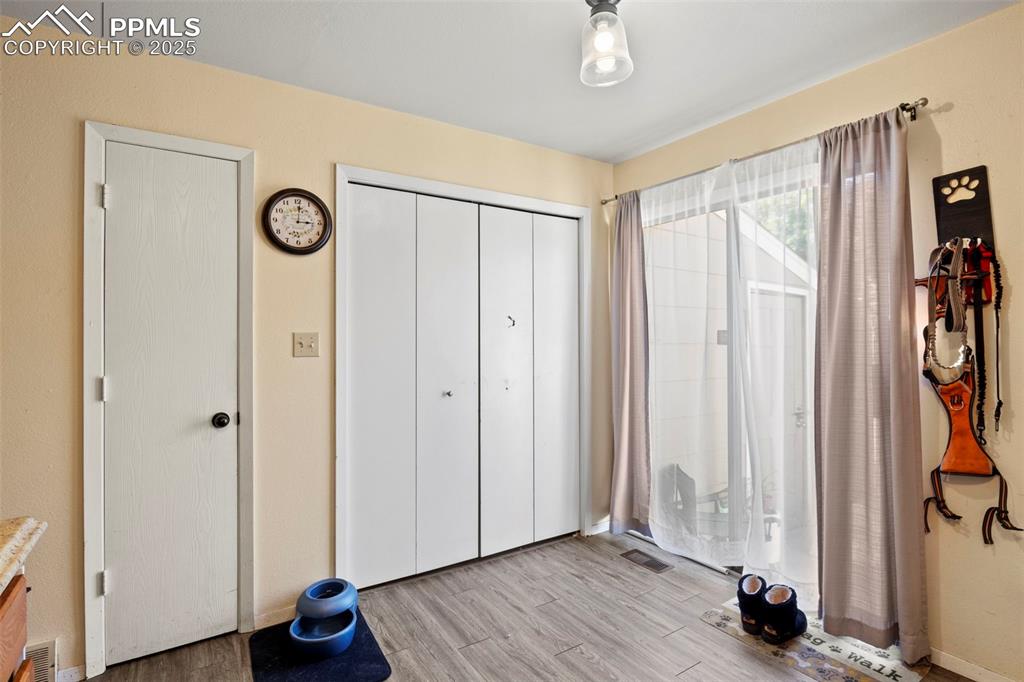 Unfurnished bedroom with wood finished floors and a closet