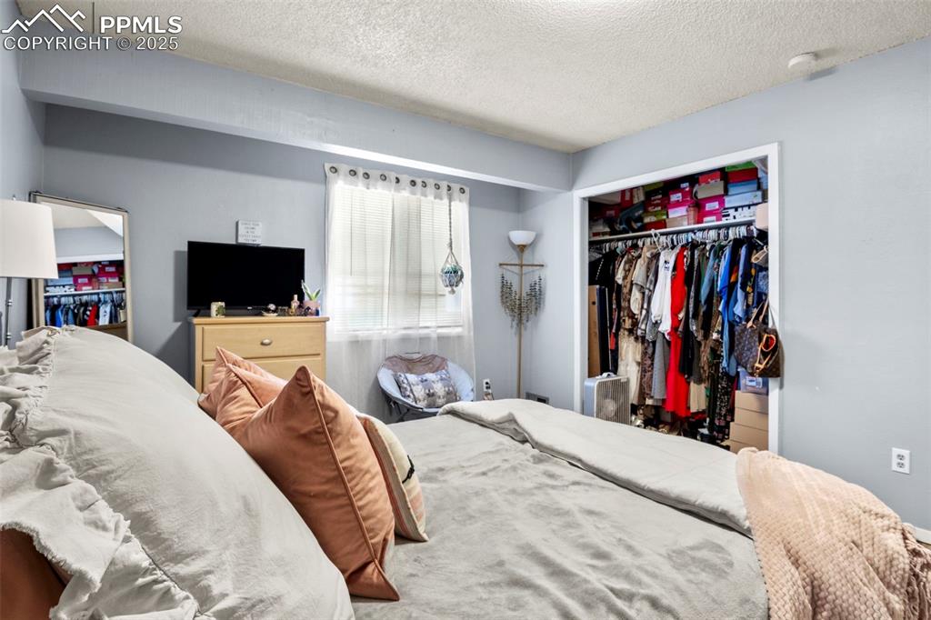 Bedroom with a closet and a textured ceiling