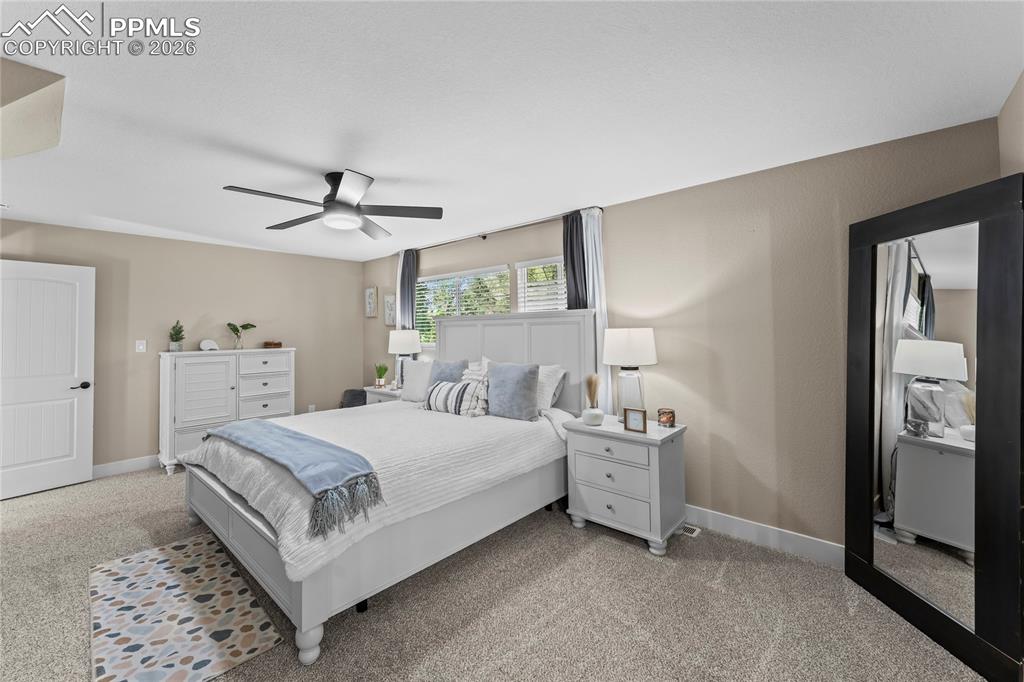 Bedroom featuring light carpet and ceiling fan