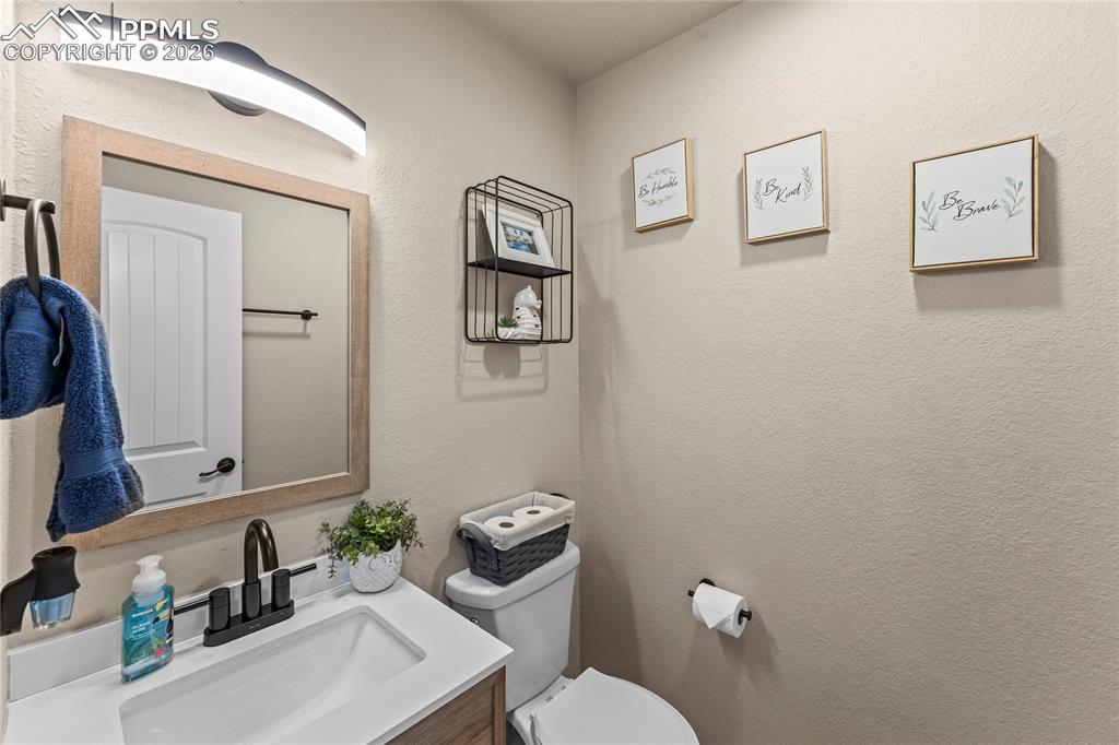 Bathroom with vanity and a textured wall