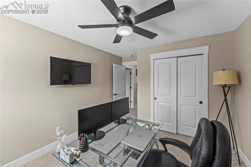 Home office featuring baseboards and ceiling fan