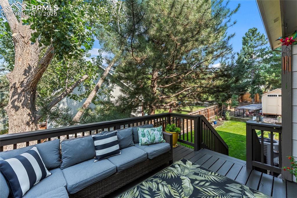 Deck with an outdoor hangout area and a yard