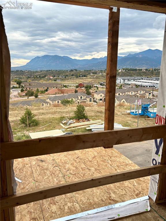 View of mountain backdrop featuring nearby suburban area