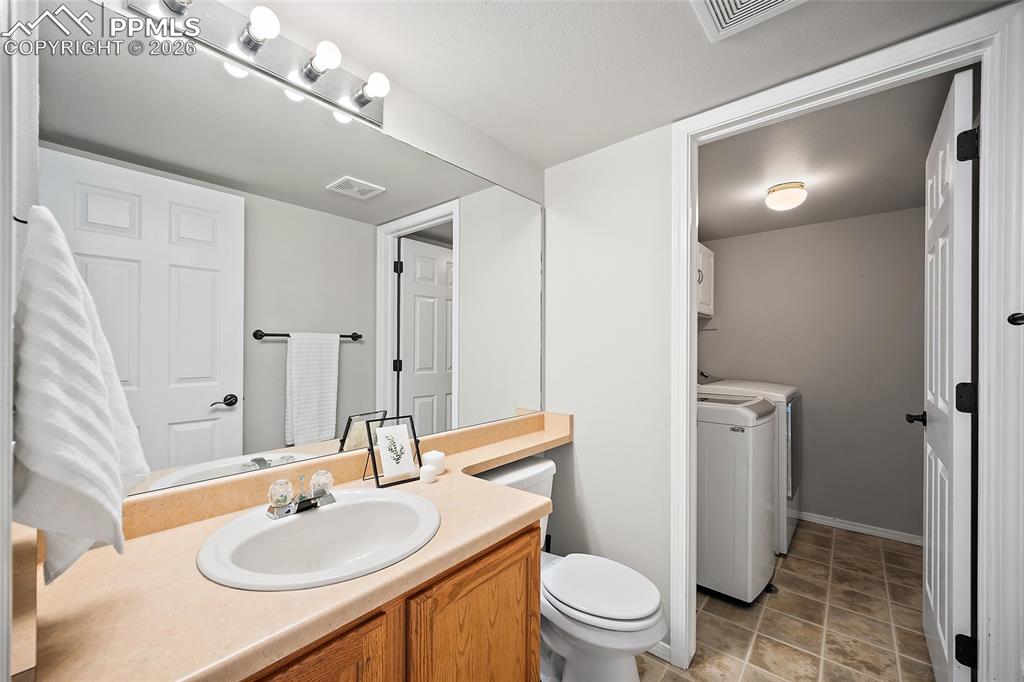 Bathroom with vanity and washer and dryer