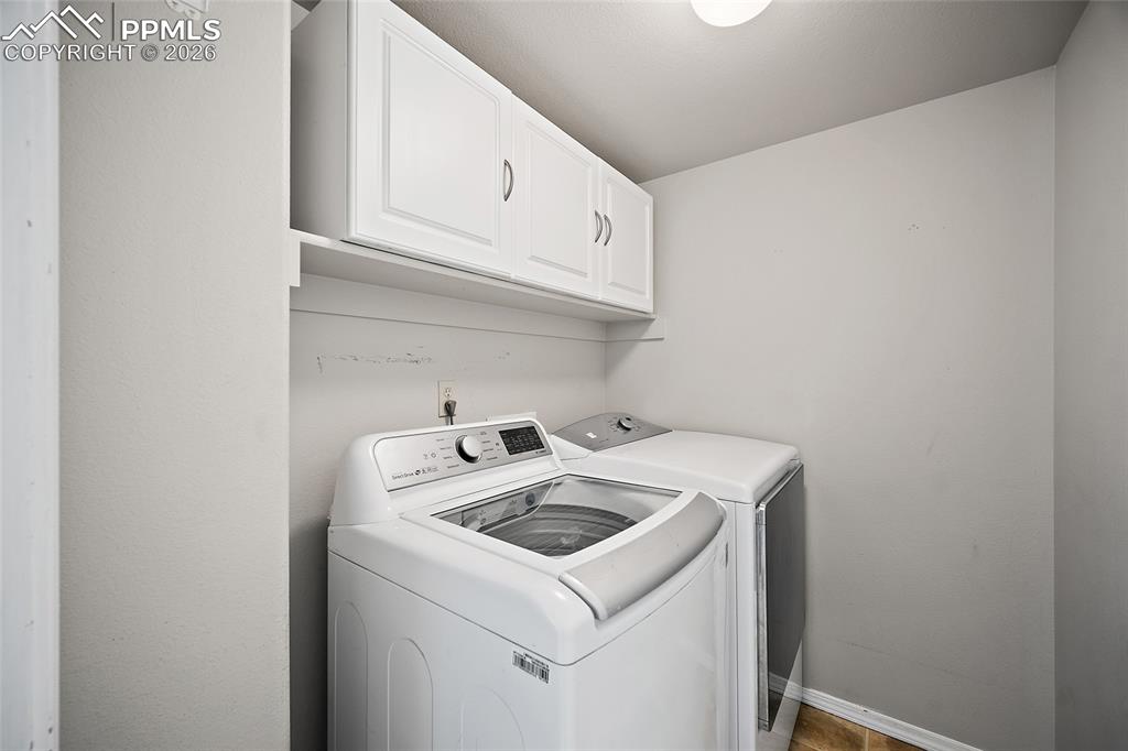 Laundry room with cabinet space and washing machine and dryer