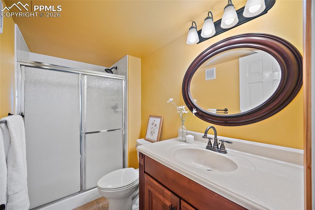 Full bath with vanity and a stall shower