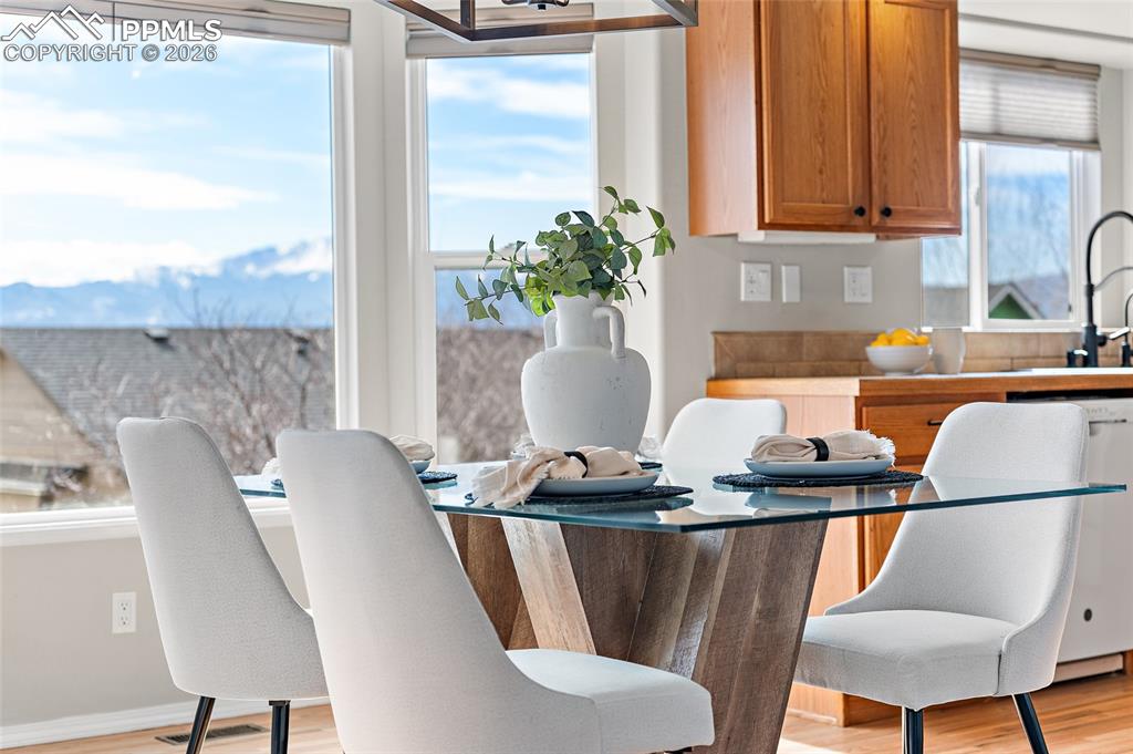 Dining room with light wood finished floors and baseboards