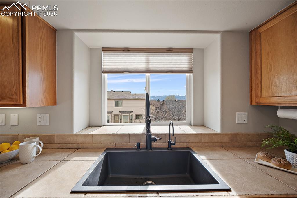 Kitchen featuring wood finish cabinetry, tile countertops, and a mountain view