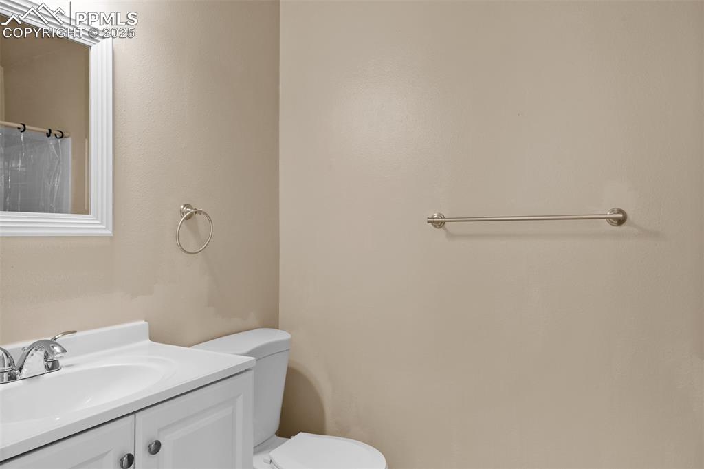 Full bathroom on upper level adjacent to bedroom 2 featuring vanity and a shower with curtain