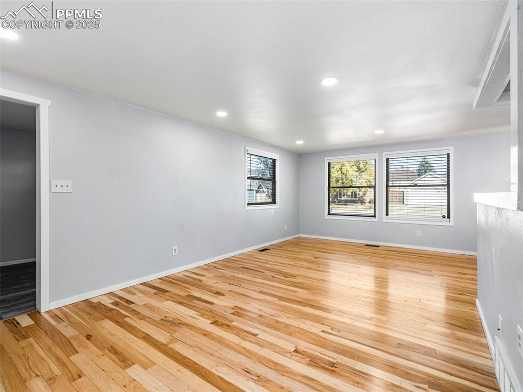 Unfurnished room with light wood-style flooring and recessed lighting