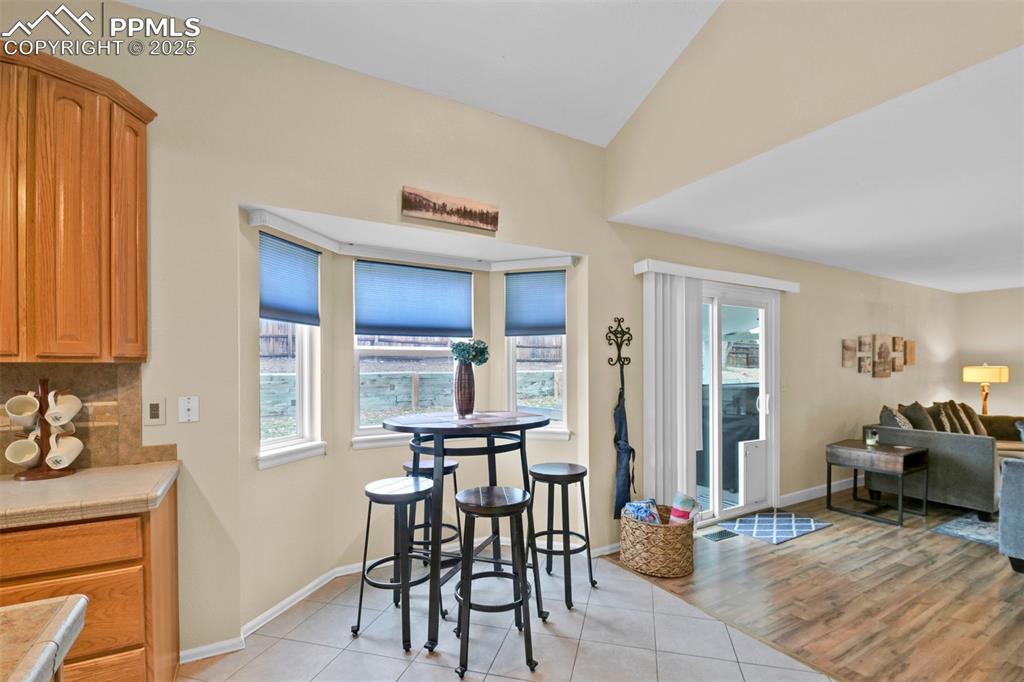 Dining room with light tile patterned floors and baseboards