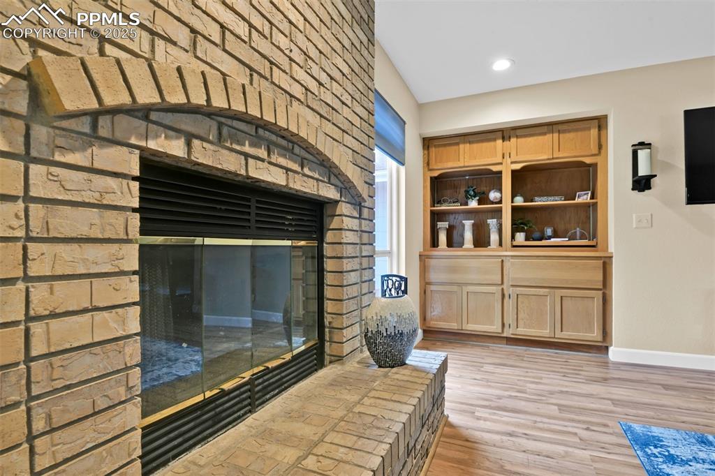 Detailed view of wood finished floors and recessed lighting