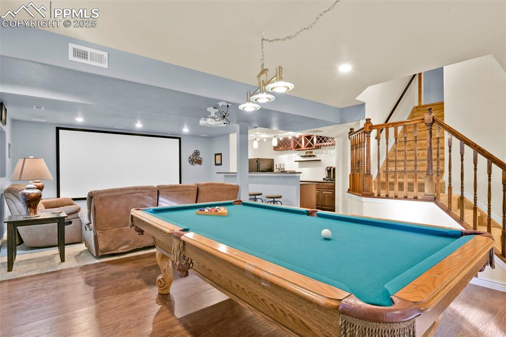 Recreation room featuring bar, wood finished floors, pool table, and recessed lighting