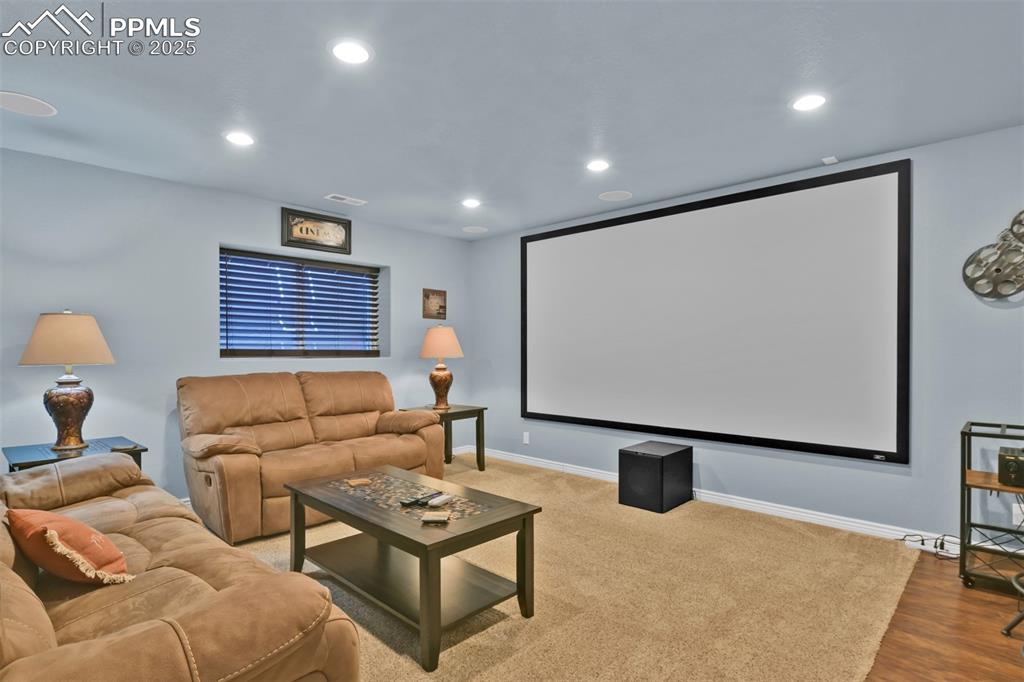 Cinema featuring recessed lighting and wood finished floors