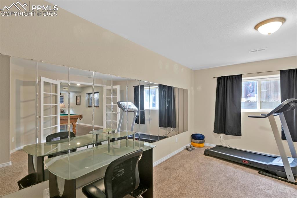 Workout area with carpet flooring and billiards