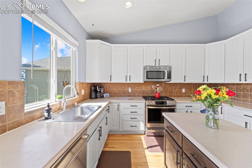 Kitchen with stainless appliances and views

