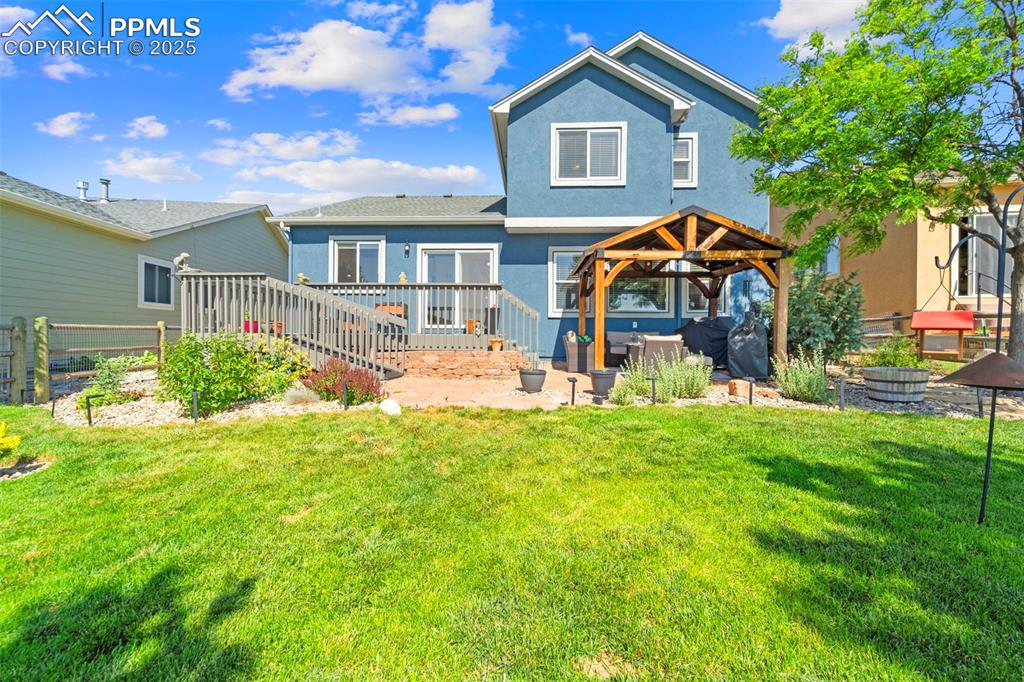 Back of home with patio access