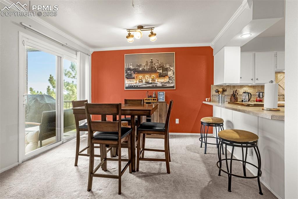Dining area, opens to the new composite deck and mountain views.